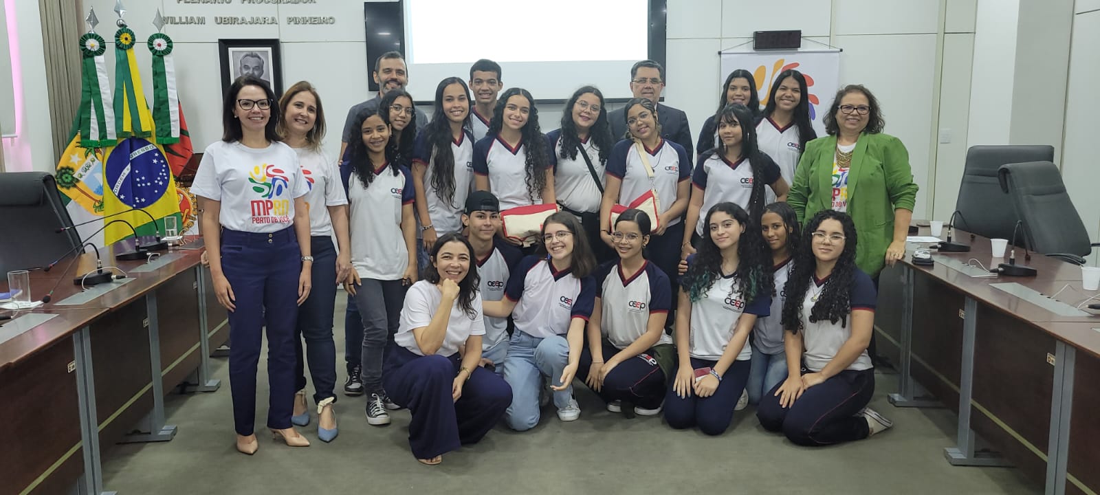 Imagem de vários estudantes ao lado de professores, promotores e procuradores de Justiça, no plenário da PGJ.